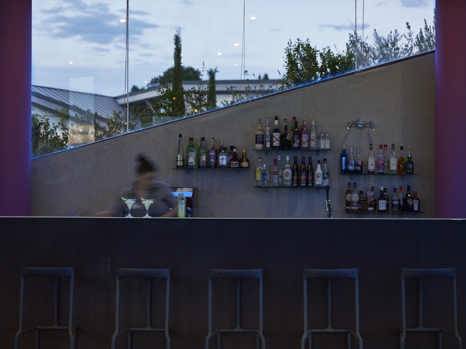 Bar with wine and cocktail bottles at twilight