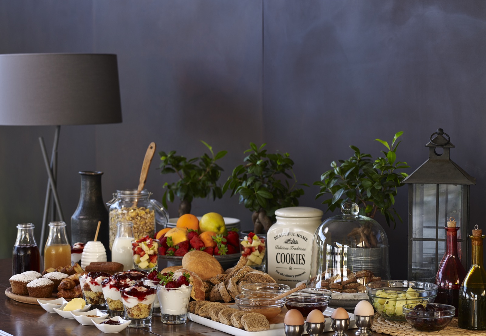 Breakfast spread — bread, fruits, juices, pastries, eggs